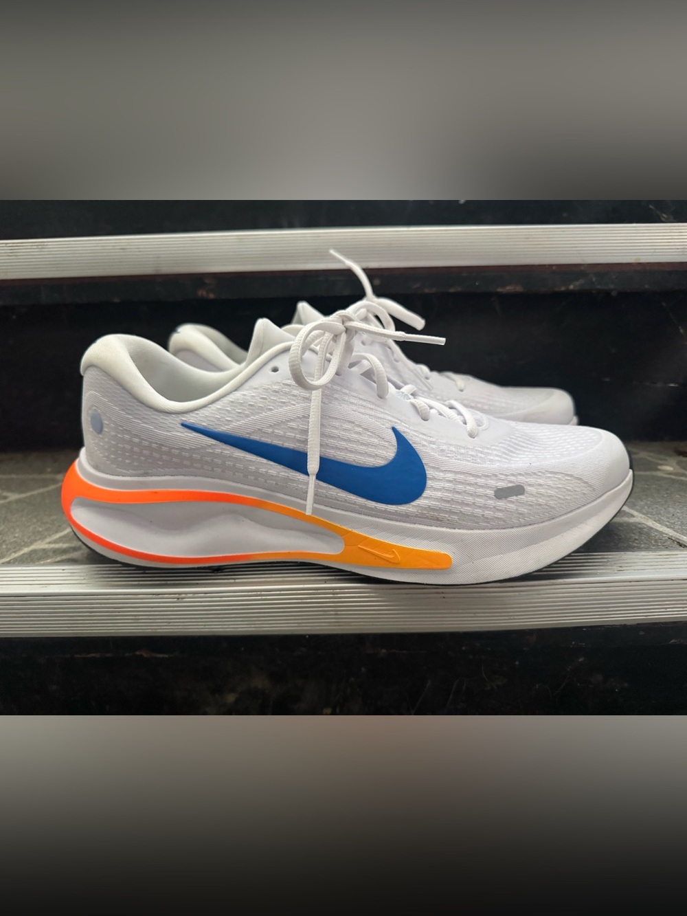 Nike Men's White Running Shoes with Blue Swoosh and Orange Accent